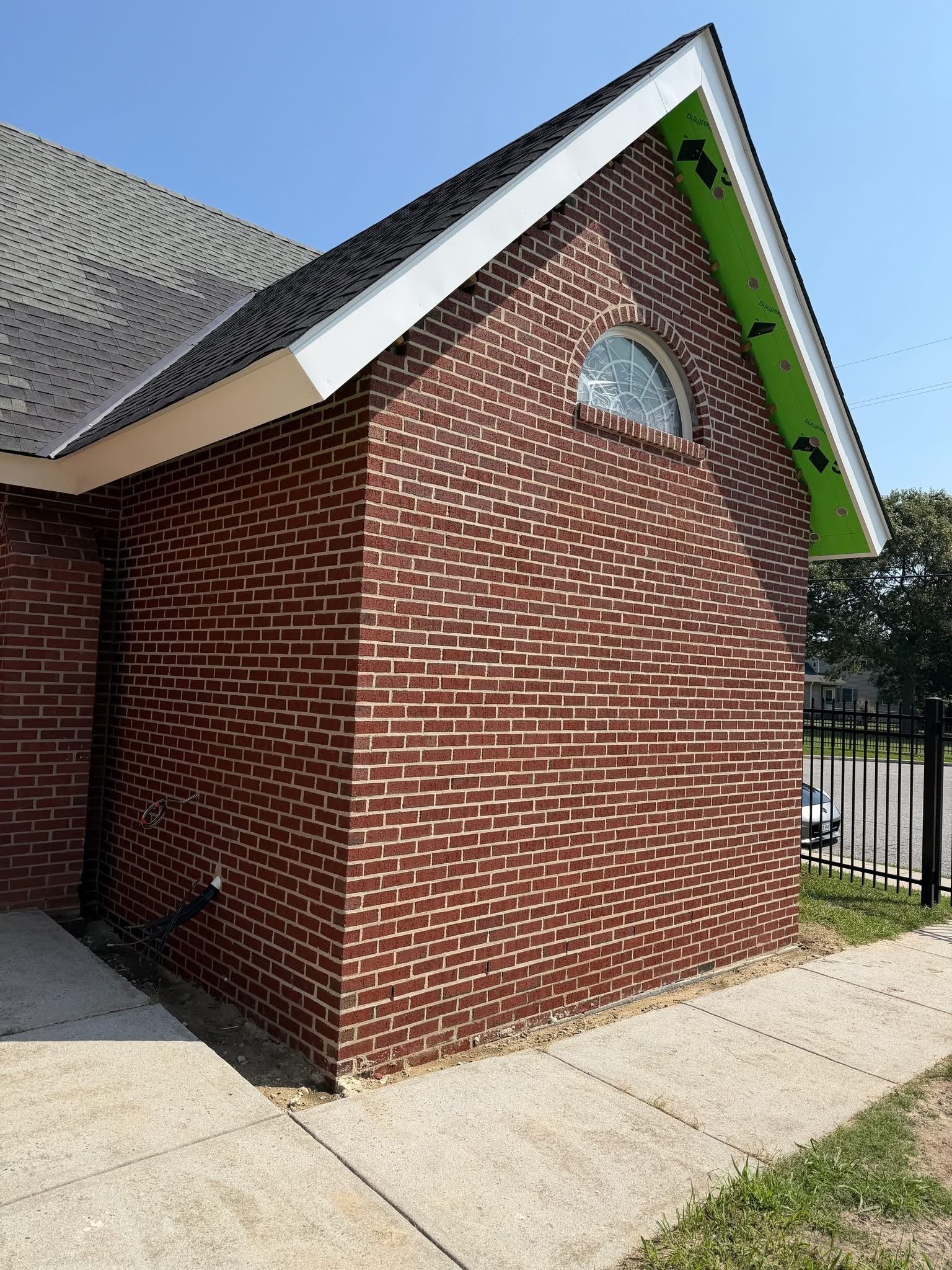 Brick veneer masonry on a gable end, nearing completion