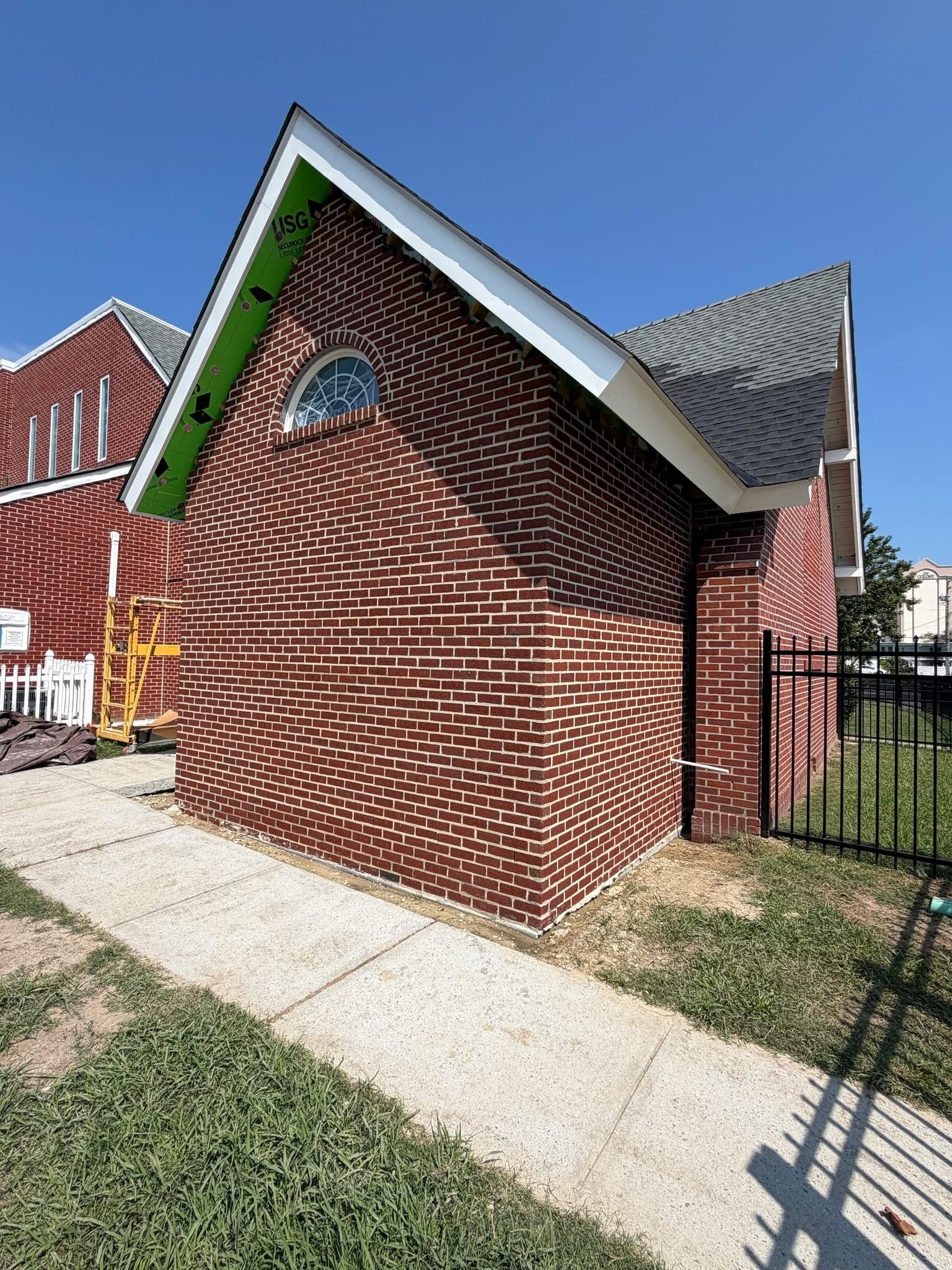 Brick veneer masonry on a gable end, second angle, nearing completion